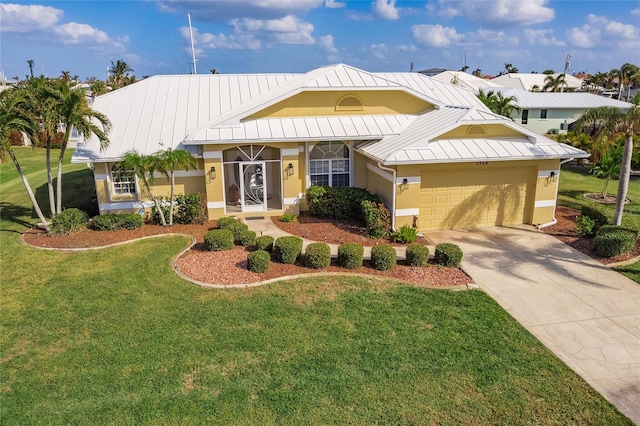 view of front of property featuring a garage and a front yard