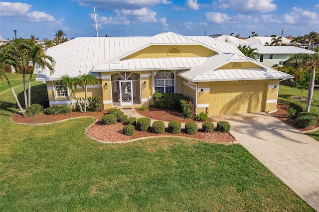 2868 Coral Way, Punta Gorda, FL 33950 - view of front facade featuring a standing seam roof, a garage, stucco siding, and metal roof