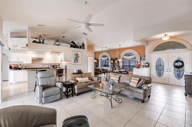 2868 Coral Way, Punta Gorda, FL 33950 - living area featuring light tile patterned floors, lofted ceiling, ceiling fan, and washing machine and dryer