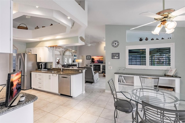 2868 Coral Way, Punta Gorda, FL 33950 - kitchen with a ceiling fan, appliances with stainless steel finishes, white cabinets, a peninsula, and light tile patterned floors