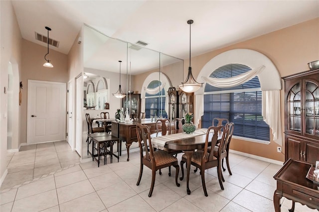 dining space featuring light tile patterned flooring