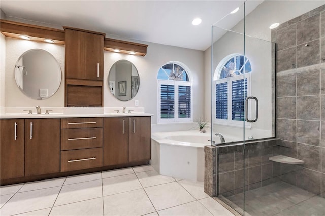 bathroom featuring vanity, tile patterned floors, and plus walk in shower