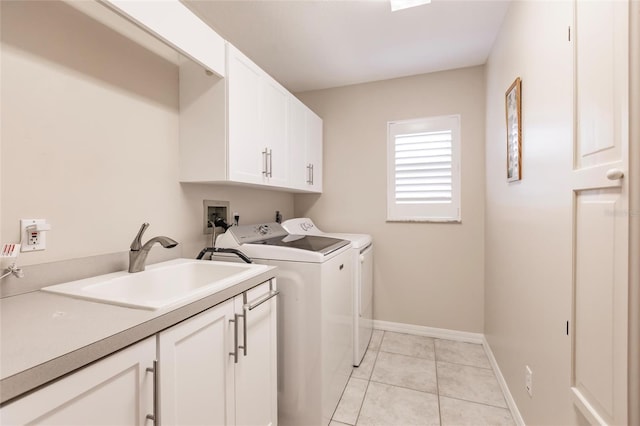 washroom featuring light tile patterned flooring, cabinets, sink, and separate washer and dryer