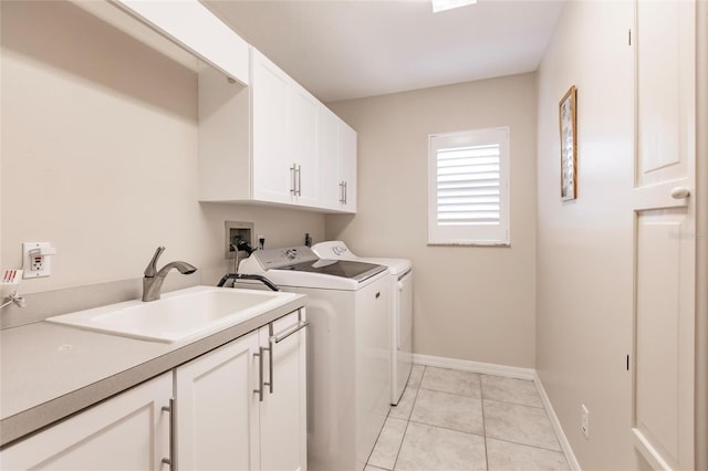 2868 Coral Way, Punta Gorda, FL 33950 - laundry area featuring cabinet space, washer and dryer, baseboards, and light tile patterned floors