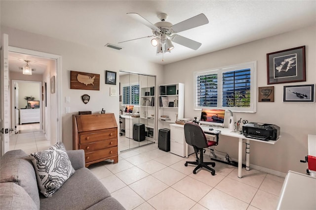 office space featuring ceiling fan and light tile patterned floors