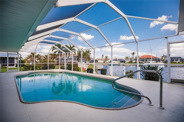 view of pool featuring a water view, glass enclosure, and a patio