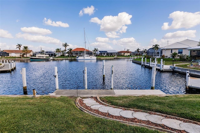 dock area featuring a lawn and a water view