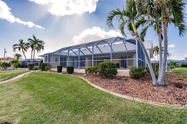 exterior space with a lawn and a lanai