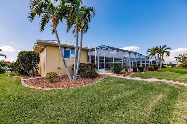 2868 Coral Way, Punta Gorda, FL 33950 - back of house featuring stucco siding, a yard, and glass enclosure