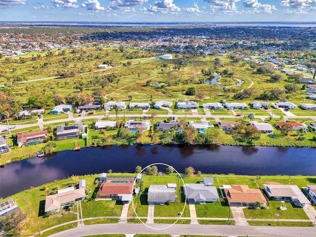 birds eye view of property with a water view and a residential view