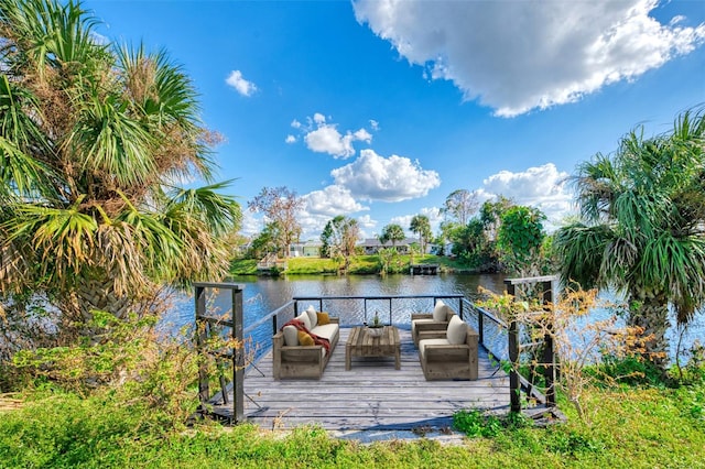 dock area with outdoor lounge area and a deck with water view