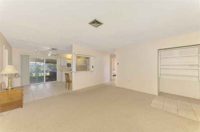 unfurnished living room with ceiling fan and light carpet