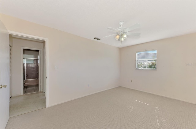 spare room with carpet flooring and ceiling fan