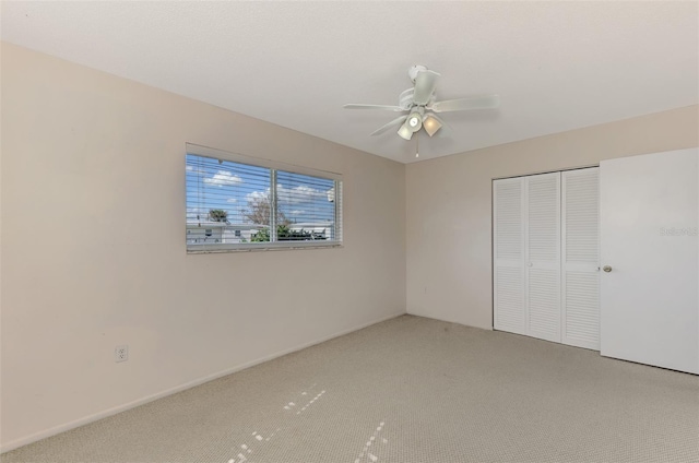 unfurnished bedroom featuring ceiling fan, carpet floors, and a closet