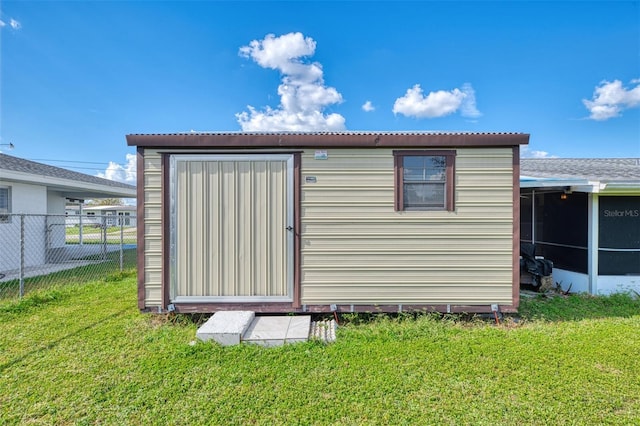 view of outbuilding with a yard