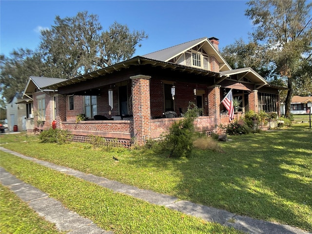 view of property exterior with a yard and covered porch