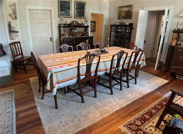 dining area with dark hardwood / wood-style floors