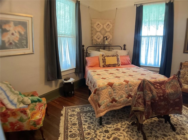 bedroom with dark wood-type flooring