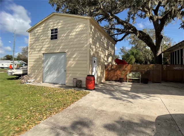 view of home's exterior with a garage and a lawn