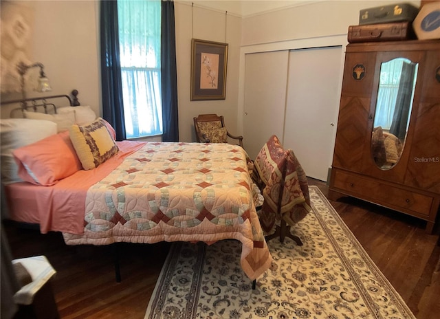 bedroom featuring dark hardwood / wood-style flooring and a closet