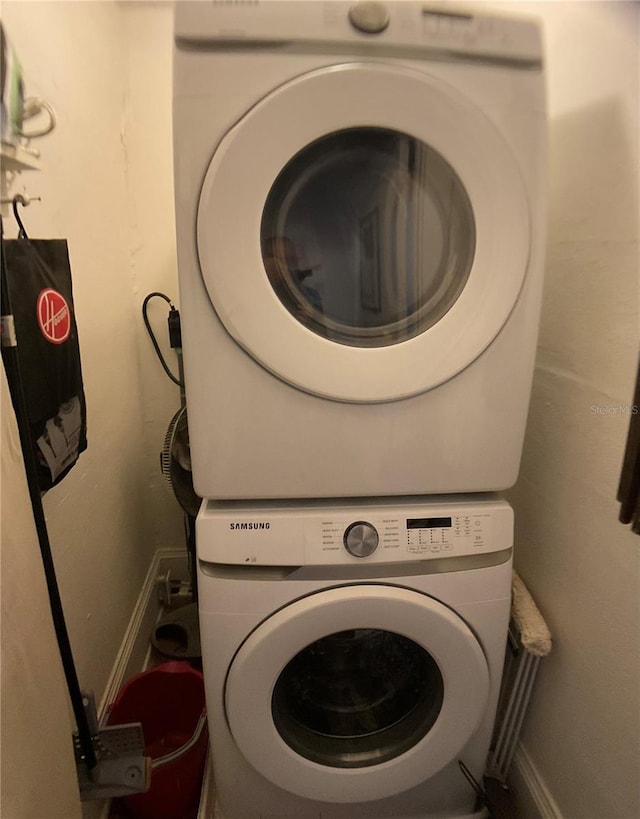 laundry room featuring stacked washing maching and dryer