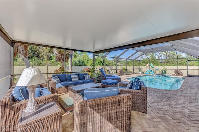 view of swimming pool featuring an outdoor hangout area, a patio, and a lanai