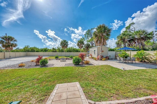 view of yard featuring a patio area and an outbuilding