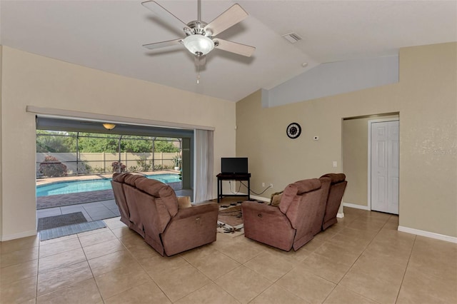 tiled living room featuring ceiling fan and vaulted ceiling