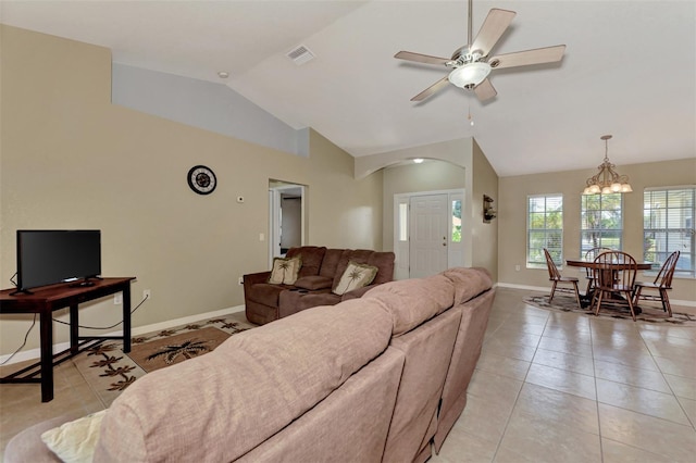 living room with light tile patterned floors, vaulted ceiling, and ceiling fan with notable chandelier