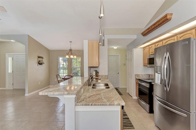 kitchen with sink, kitchen peninsula, stainless steel appliances, pendant lighting, and light stone counters