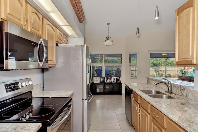 kitchen with sink, hanging light fixtures, stainless steel appliances, light stone counters, and light tile patterned floors