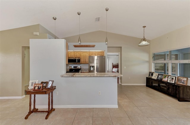 kitchen featuring light stone countertops, lofted ceiling, appliances with stainless steel finishes, and light tile patterned floors