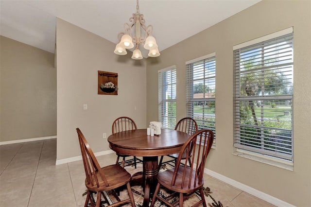 tiled dining space with a chandelier