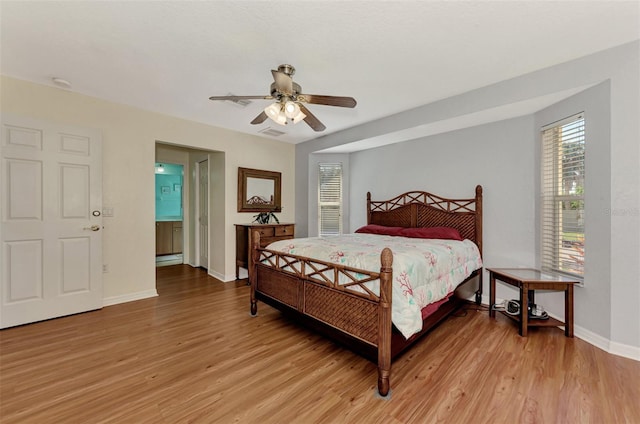 bedroom featuring connected bathroom, ceiling fan, and light hardwood / wood-style floors