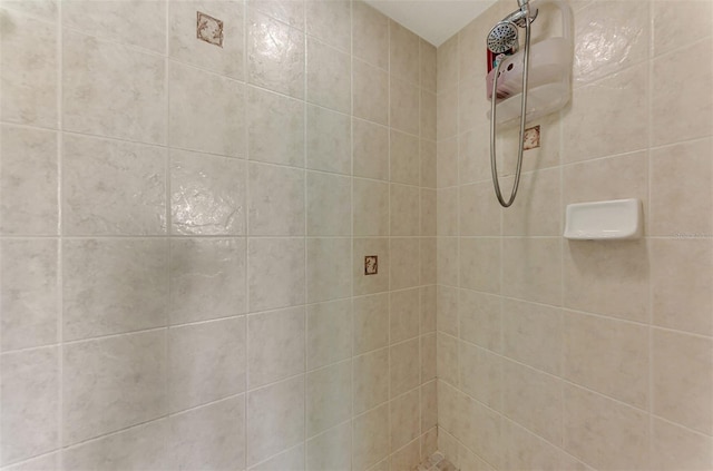 bathroom with tiled shower