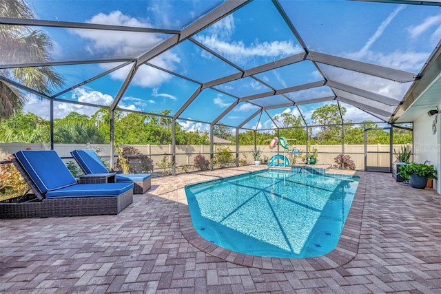 view of swimming pool with a patio area and a lanai