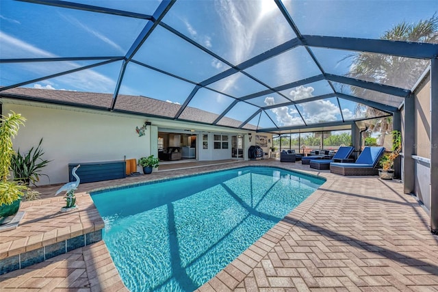 view of pool featuring a patio, a lanai, and a jacuzzi