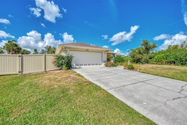 view of front of property with a garage and a front lawn