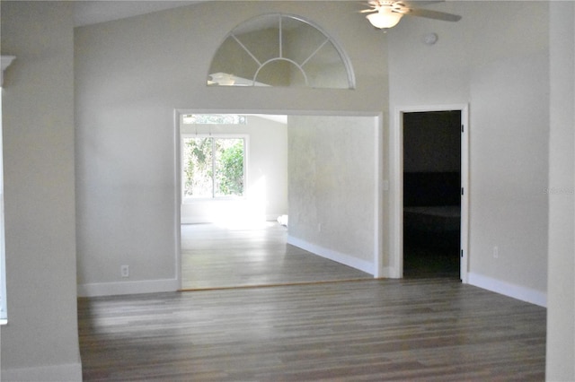 empty room featuring ceiling fan, dark hardwood / wood-style flooring, and high vaulted ceiling