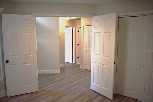 corridor with light hardwood / wood-style floors