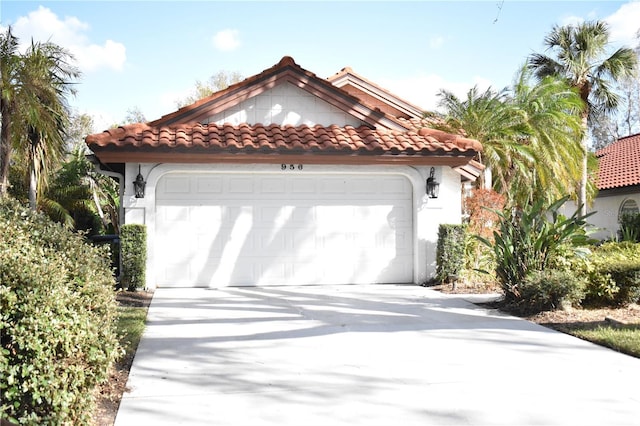 956 Harbor Town Dr, Venice, FL 34292 - mediterranean / spanish-style home with a tiled roof, concrete driveway, a garage, and stucco siding