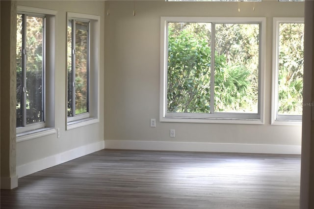 unfurnished room featuring dark hardwood / wood-style flooring