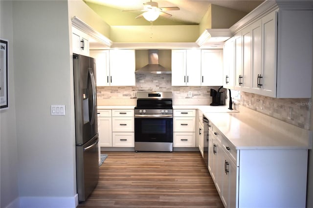 kitchen with decorative backsplash, wall chimney exhaust hood, stainless steel appliances, sink, and white cabinetry