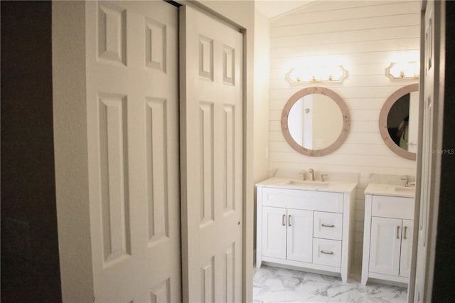 bathroom with wood walls and vanity