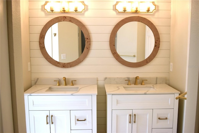 bathroom with vanity and wooden walls