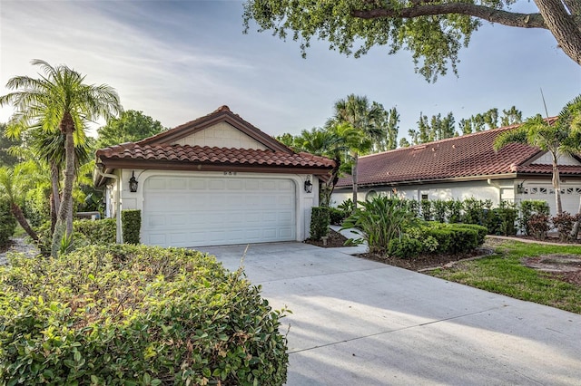 956 Harbor Town Dr, Venice, FL 34292 - mediterranean / spanish-style home featuring a tiled roof, stucco siding, and driveway