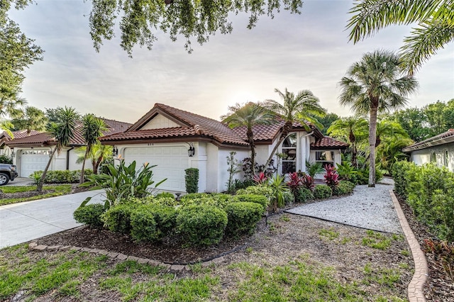 956 Harbor Town Dr, Venice, FL 34292 - mediterranean / spanish home with a tiled roof, an attached garage, and stucco siding