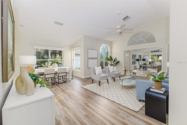956 Harbor Town Dr, Venice, FL 34292 - living room featuring plenty of natural light, light wood-style flooring, ceiling fan, high vaulted ceiling, and baseboards