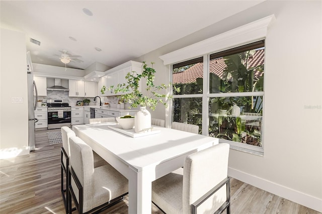 956 Harbor Town Dr, Venice, FL 34292 - dining space with light wood-style flooring, baseboards, and ceiling fan