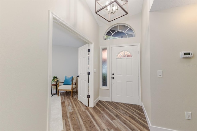 956 Harbor Town Dr, Venice, FL 34292 - entryway with light wood-type flooring, a chandelier, and baseboards